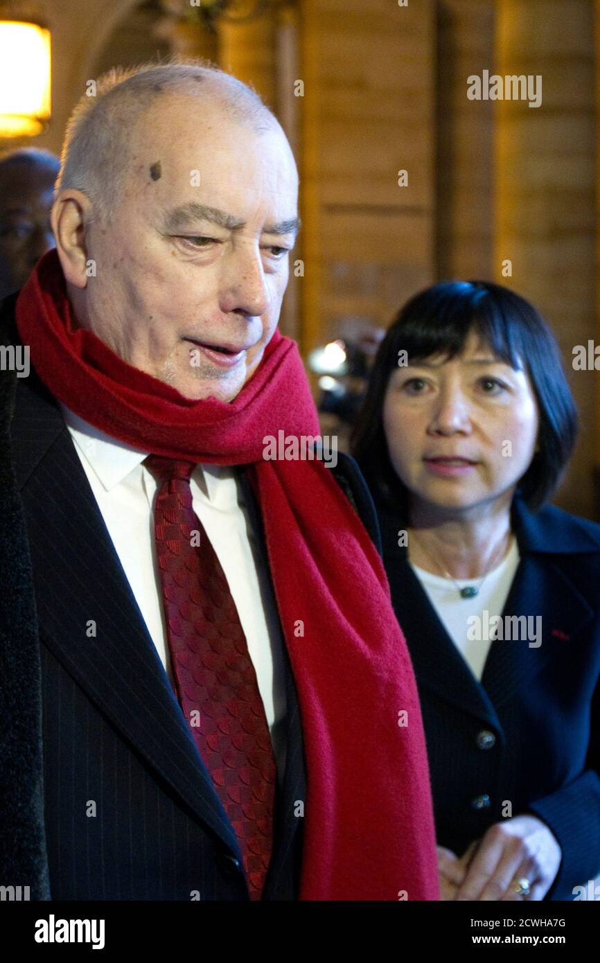 Former French Force Ouvriere trade union leader Marc Blondel (L) and Anh  Dao Traxel, the adopted daughter of former French President Jacques Chirac,  leave after the verdict in the trial of Jacques