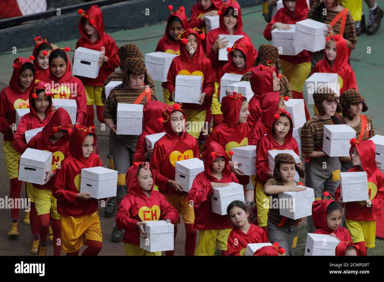 El Actor Del Chavo Del 8 Children, dressed as "El Chapulin Colorado" and "El Chavo del 8",  characters by late screenwriter Roberto Gomez Bolanos, carry white boxes  with doves inside, as they arrive to a memorial in memory