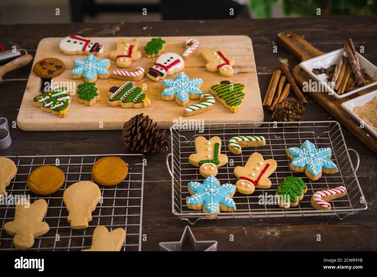 Petits gâteaux de Noël fraîchement cuits sur une table en bois. Vue de dessus de l'arbre de Noël et des biscuits de bonhomme de neige. Banque D'Images