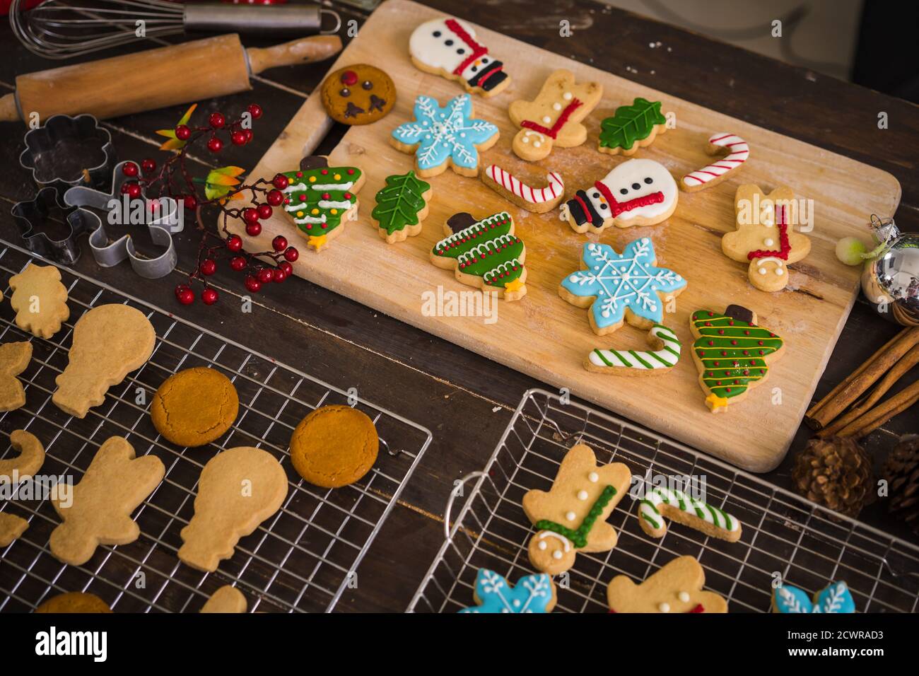 Petits gâteaux de Noël fraîchement cuits sur une table en bois. Vue de dessus de l'arbre de Noël et des biscuits de bonhomme de neige. Banque D'Images