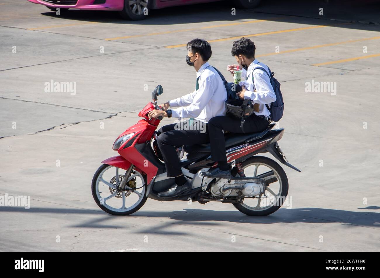 SAMUT PRAKAN, THAÏLANDE, JUL 29 2020, UN deux garçons en chemise blanche se  rassemblent sur une moto Photo Stock - Alamy