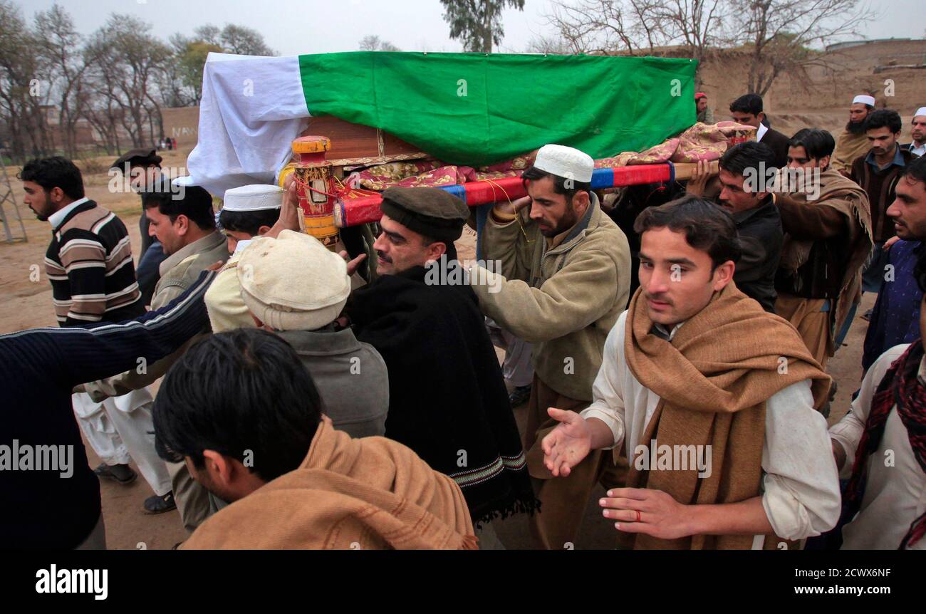 Relatives and residents carry the flagdraped casket of soldier