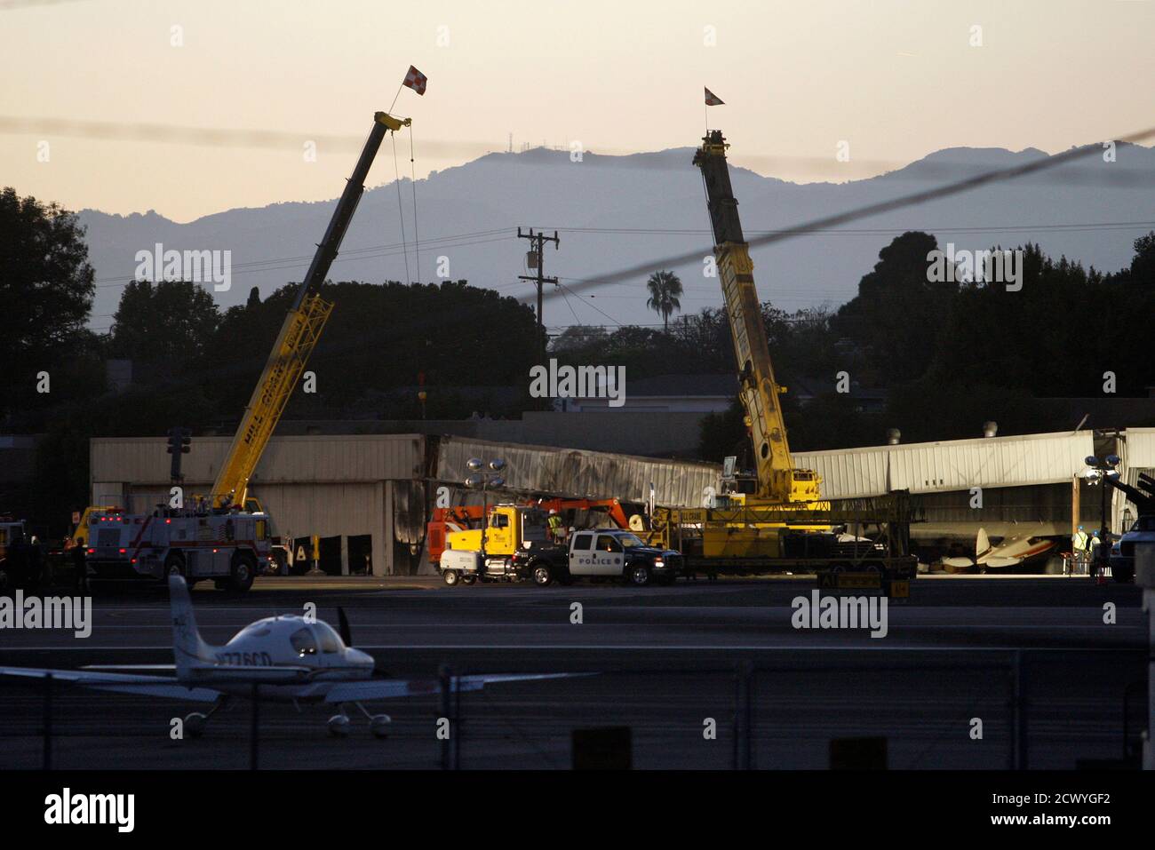 Workers Prepare To Use Cranes To Extract A Twin Engine Cessna Citation 525a Aircraft From Inside A Collapsed Hangar Which It Slammed Into Bursting Into Flames After It Touched Down Last Night In