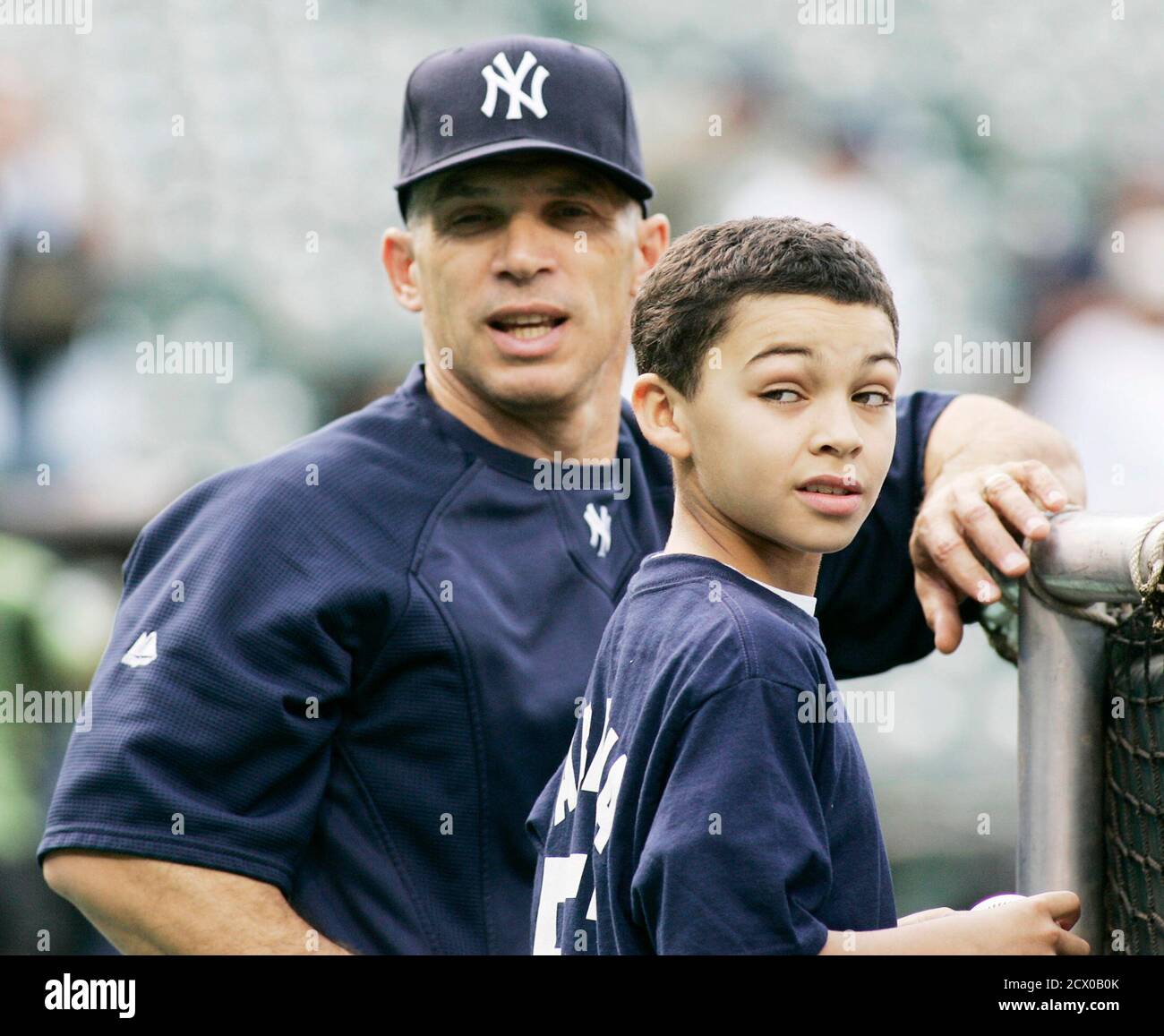 New York Yankees manager Joe Girardi (L) is shown with Yankees fan,  10-year-old Sean James from New York, during batting practice before the  Yankees MLB American League baseball game against the Baltimore