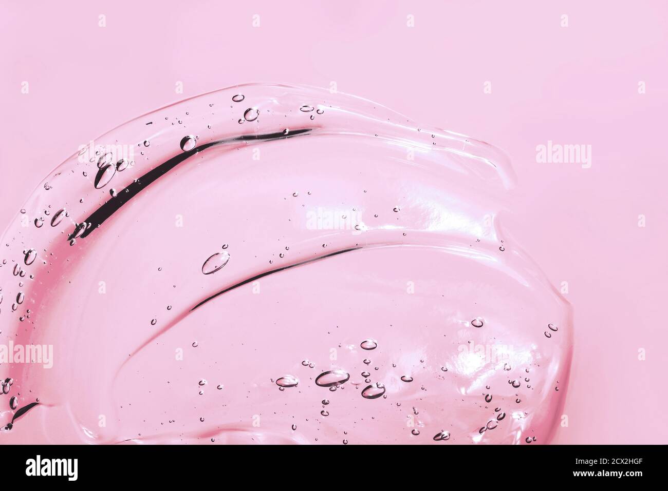 Frottis cosmétique rose transparent de gel, de sérum, de fond de beauté Banque D'Images