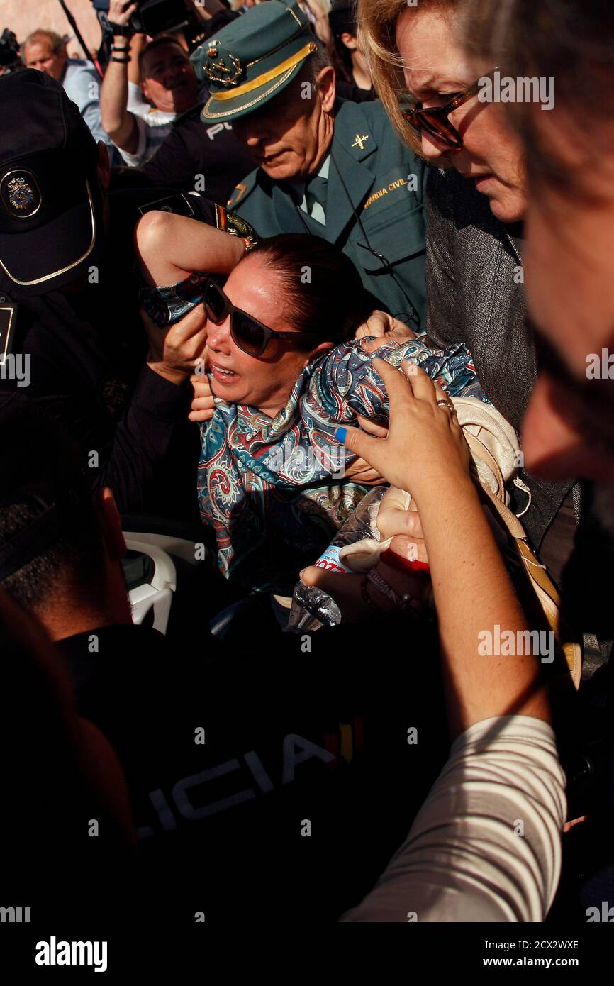 spanish-singer-isabel-pantoja-c-is-carried-by-the-spanish-civil-guard-and-police-officers-to-a-car-after-she-collapsed-while-leaving-a-court-after-listening-to-the-tribunals-sentence-of-her-trial-in-malaga-southern-spain-april-16-2013-pantoja-one-of-spains-most-flamboyant-singers-was-arrested-in-2007-after-a-construction-bribery-investigation-case-in-the-resort-town-of-marbella-in-which-her-ex-boyfriend-and-marbellas-former-mayor-julian-munoz-were-also-charged-the-judge-has-set-her-fine-to-1-14-million-euros-1-49-million-and-a-jail-sentence-of-two-years-for-multiple-money-laund-2cx2wxe.jpg
