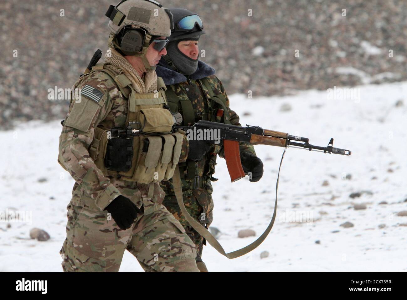 A Member Of The Special Forces Detachment Of The U.s. 3Rd Special Forces Group (L) Walks With A Member Of The Kyrgyz "Skorpion" Special Forces Unit During A Cooperative Anti-Terrorist Training Exercise