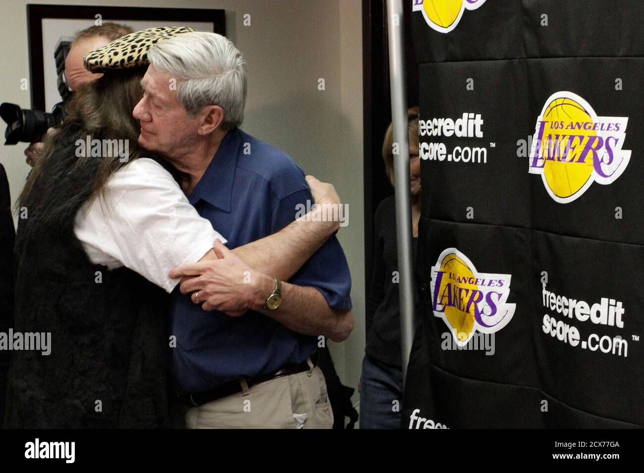 Buss family spokesman Bob Steiner (R) is embraced following a news briefing  regarding the death of longtime Lakers owner Jerry Buss, at the Lakers'  practice facility in El Segundo, California, February 18,