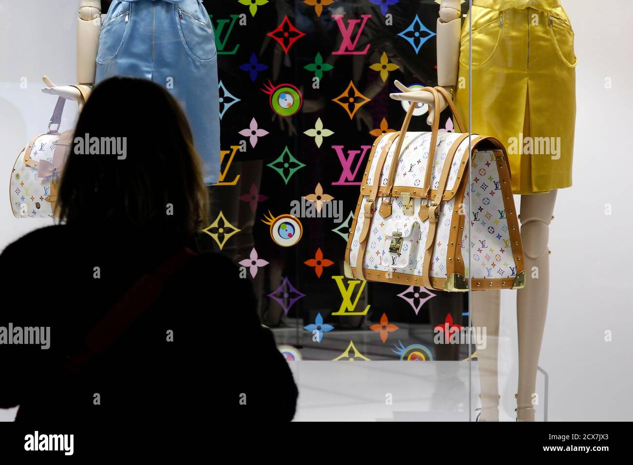 A visitor looks at fashion creations during the press presentation of the 'Louis  Vuitton - Marc Jacobs: The Exhibition' at the Museem of Decorative Arts in  Paris March 8, 2012. The exhibition,