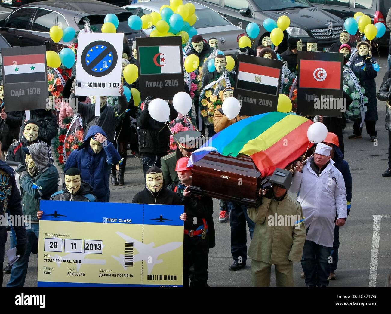 People dressed in outfits of various popular professions in Ukraine carry a  coffin symbolising Ukraine's Euro-association and an airplane ticket back  to Brussels to the EU Delegation building in Ukraine during a