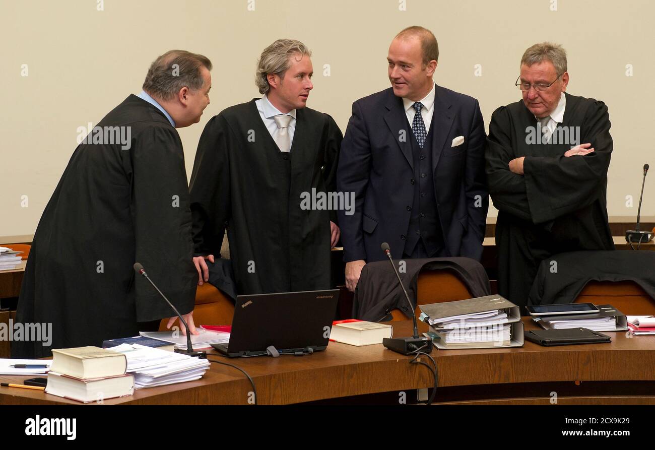 Former banker Gerhard Gribkowsky speaks with his lawyers Daniel Amelung  (L), Dirk Petri (2L) and Rainer Bruessow (R) at a district court in Munich  November 10, 2011. A former German banker, on