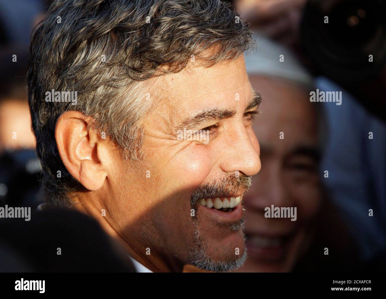 U.S. actor George Clooney smiles after South Sudan's President Salva Kiir  cast his ballot at a polling station in Juba, south Sudan January 9, 2011.  Millions of south Sudanese started voting on