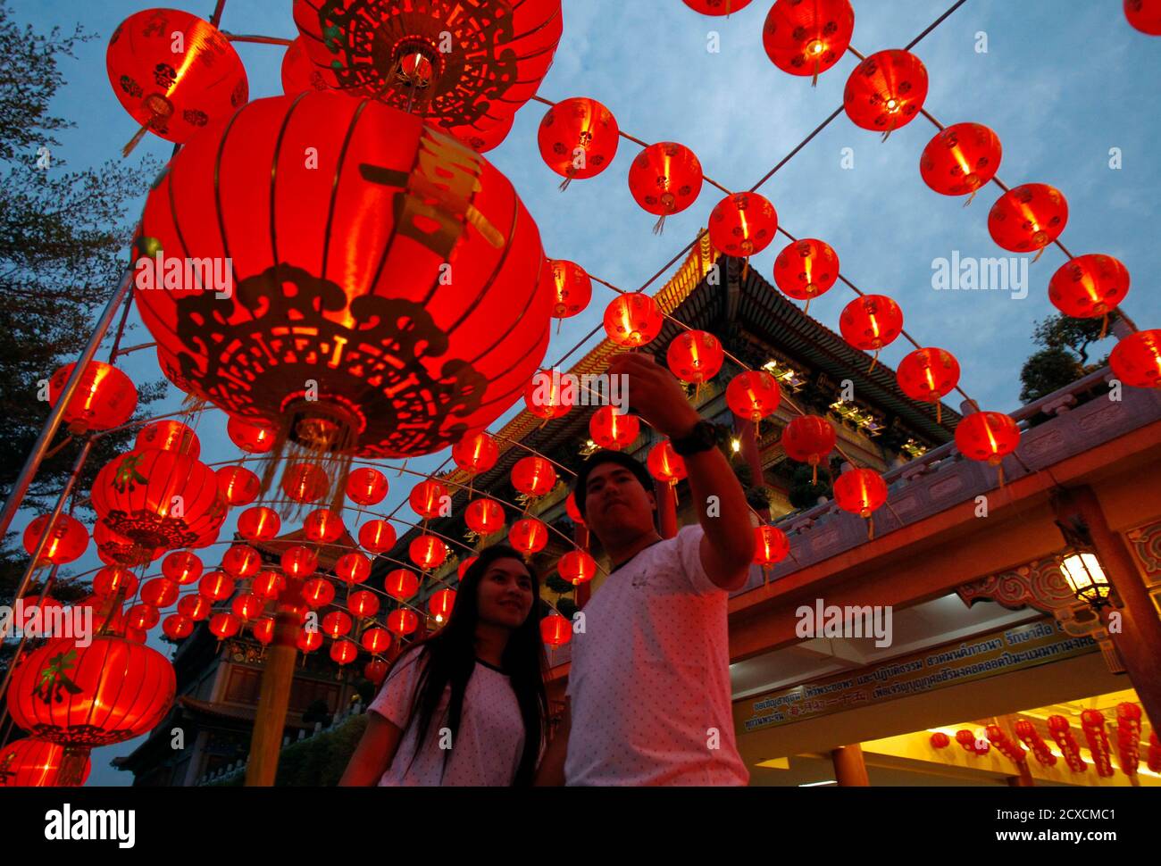 A Couple Takes A Selfie With Decorations At A Temple Ahead Of The Chinese Lunar New