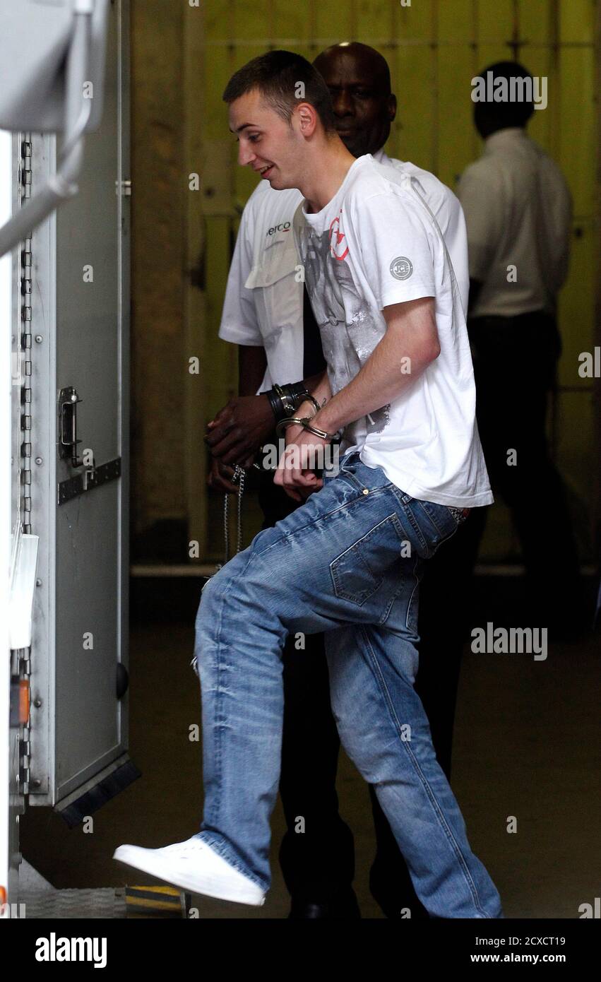 Charlie Burton aged 18 is taken from City of Westminster Magistrates' court  after pleading guilty to violent disorder during the recent riots in London  August 12, 2011. Police prepared to flood the