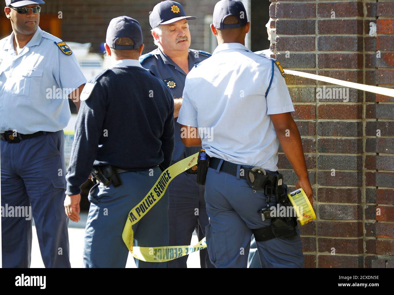 Police cordon off an area outside a Cape Town court as they await the  arrival of three men accused of killing a British tourist during her  honeymoon visit to South Africa, December