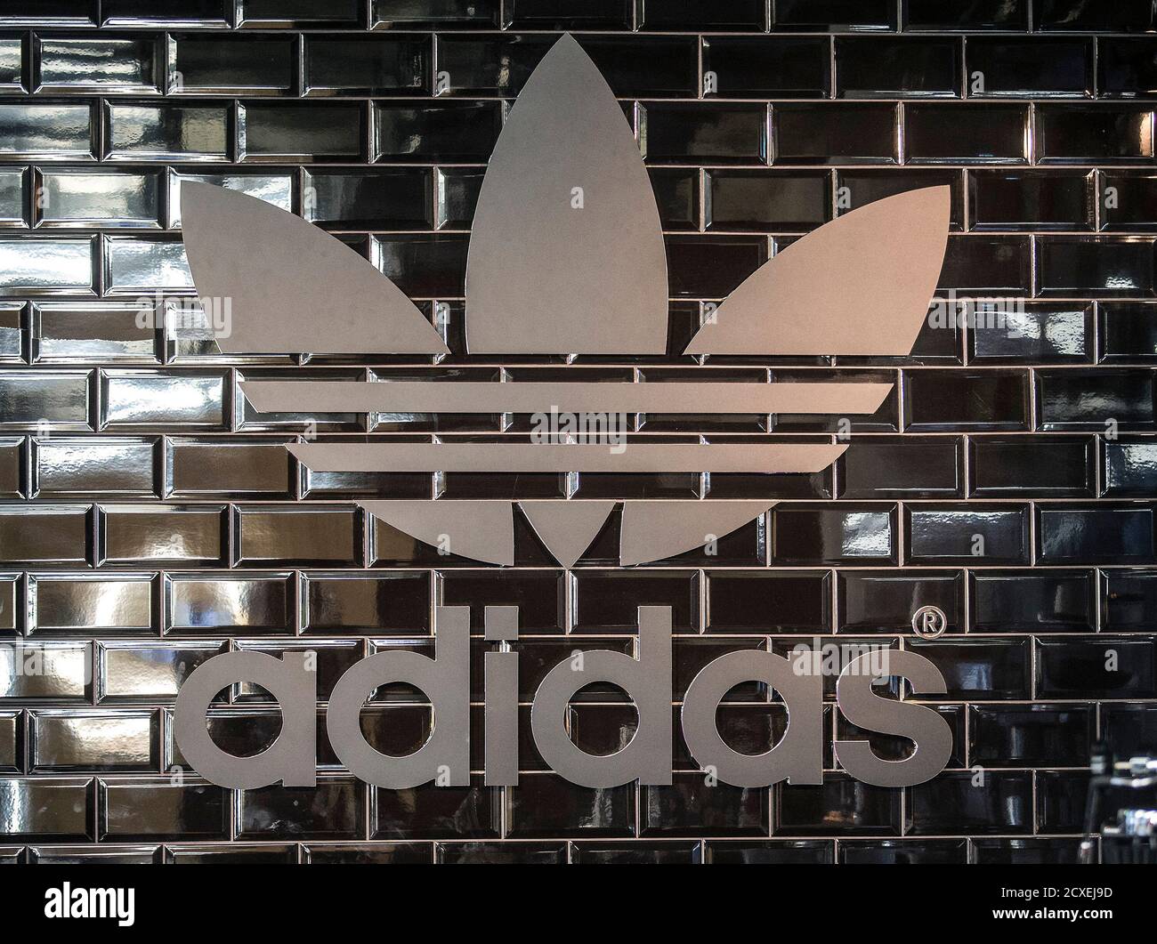 The Adidas logo is pictured in a pop-up store in Berlin December 2, 2014.  Big consumer brands have latched on to personalised products because they  seem to have a particular appeal to