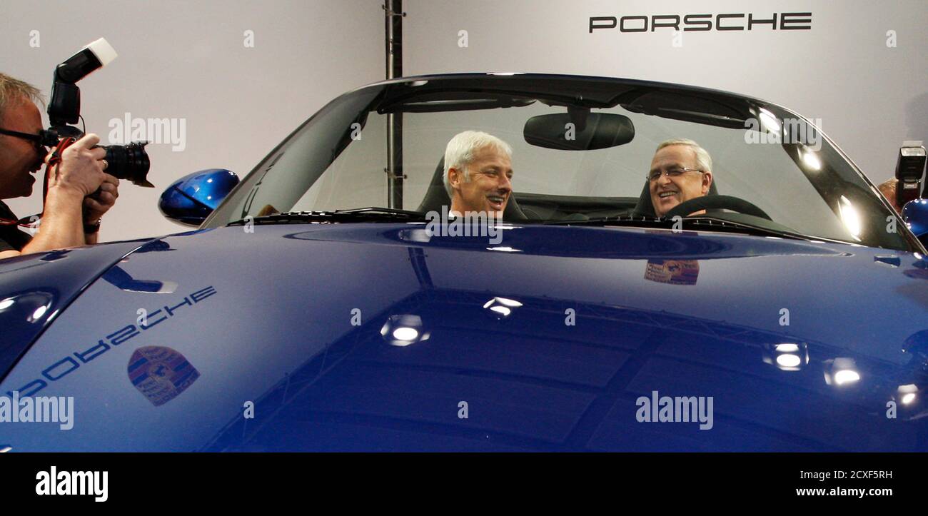 Matthias Mueller (2nd L) CEO of Porsche AG and Executive Board Member of  Porsche Automobil Holding SE and Martin Winterkorn, President and CEO of  Porsche Automobil Holding SE pose in a Porsche