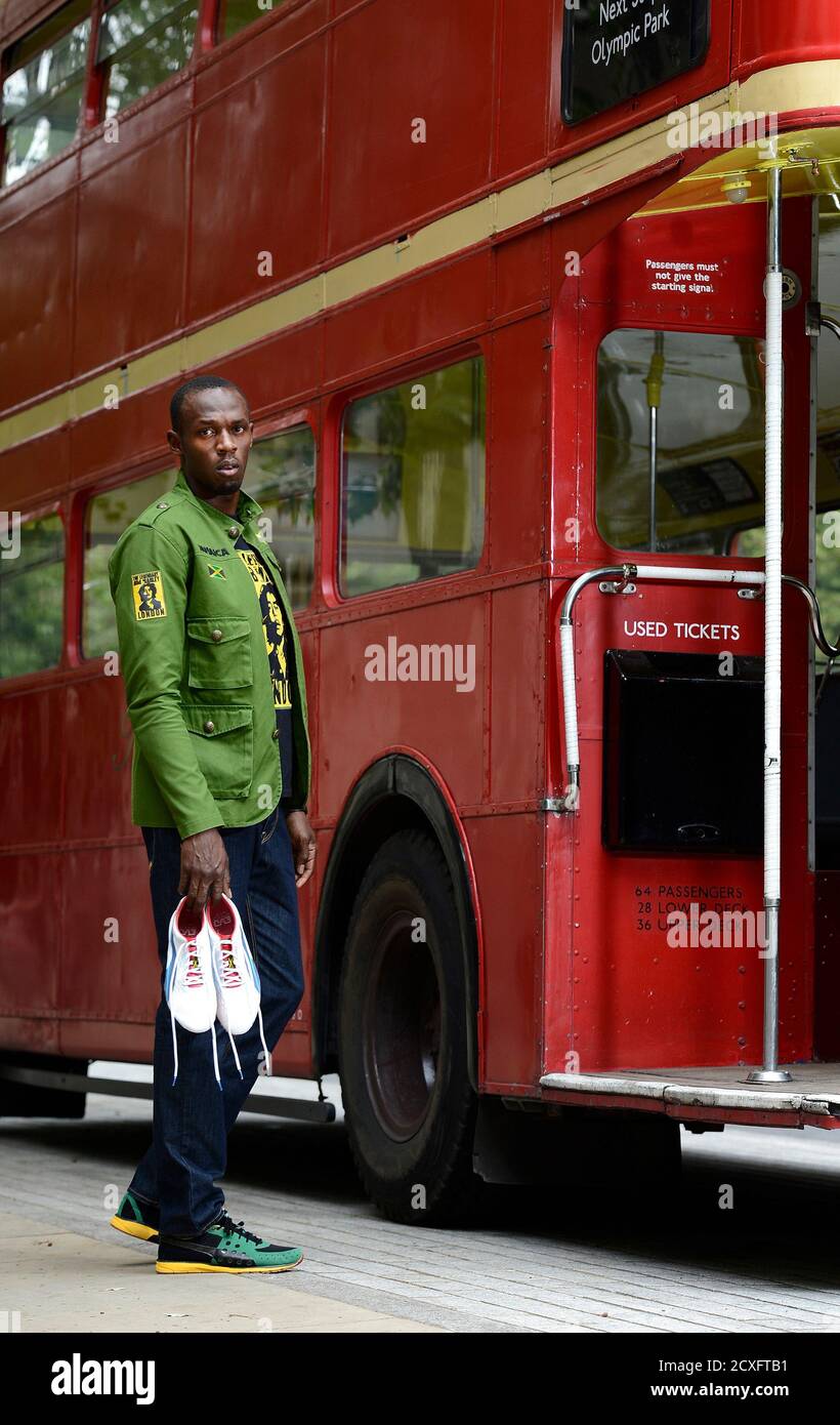 Sprinter Usain Bolt of Jamaica poses with his running spikes and official  team uniform for the London 2012 Olympic Opening Ceremony during a photo  shoot, arranged by his sponsors PUMA, beside a