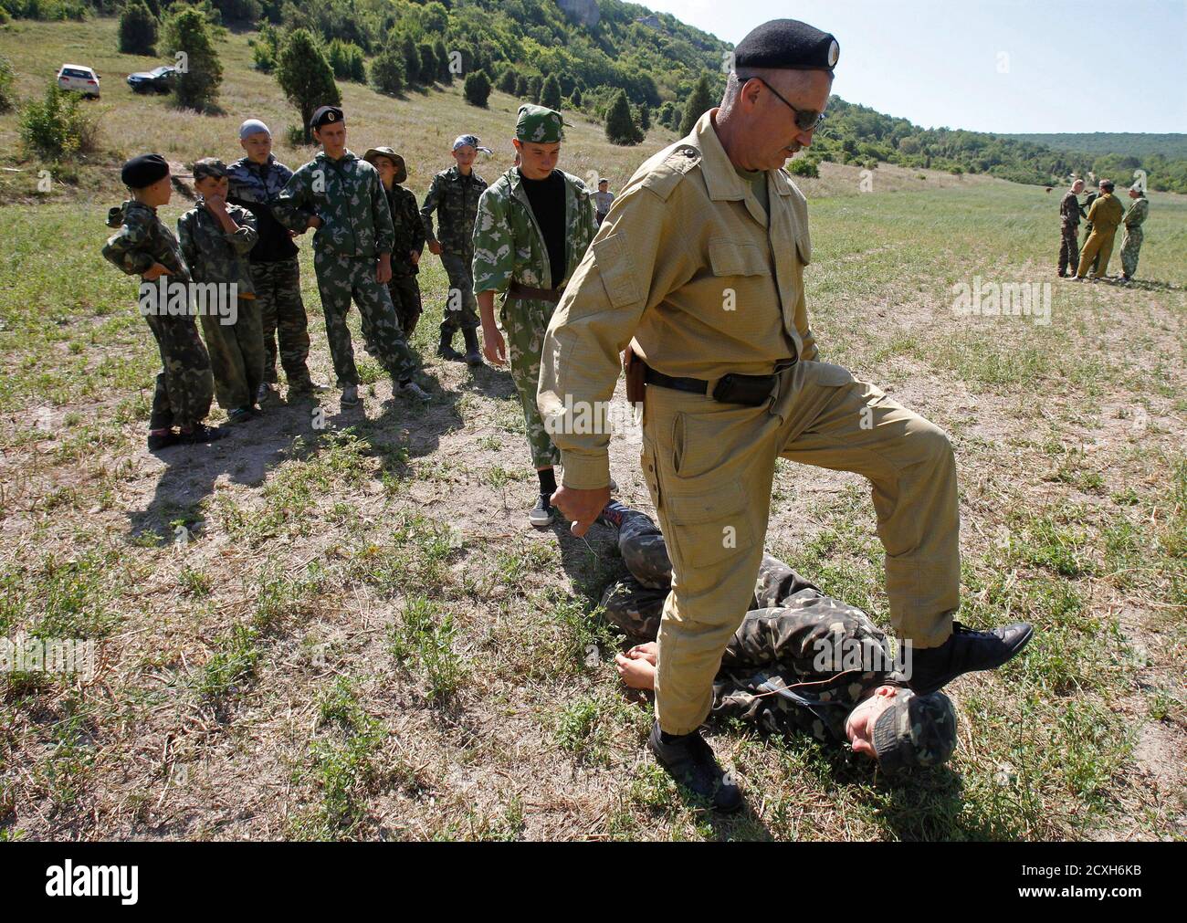 An instructor trains teenagers at a military boot camp, run by local  Cossack organisations and set up in the mountains of Crimea near the town  of Bakhchisarai August 4, 2011. Some 100