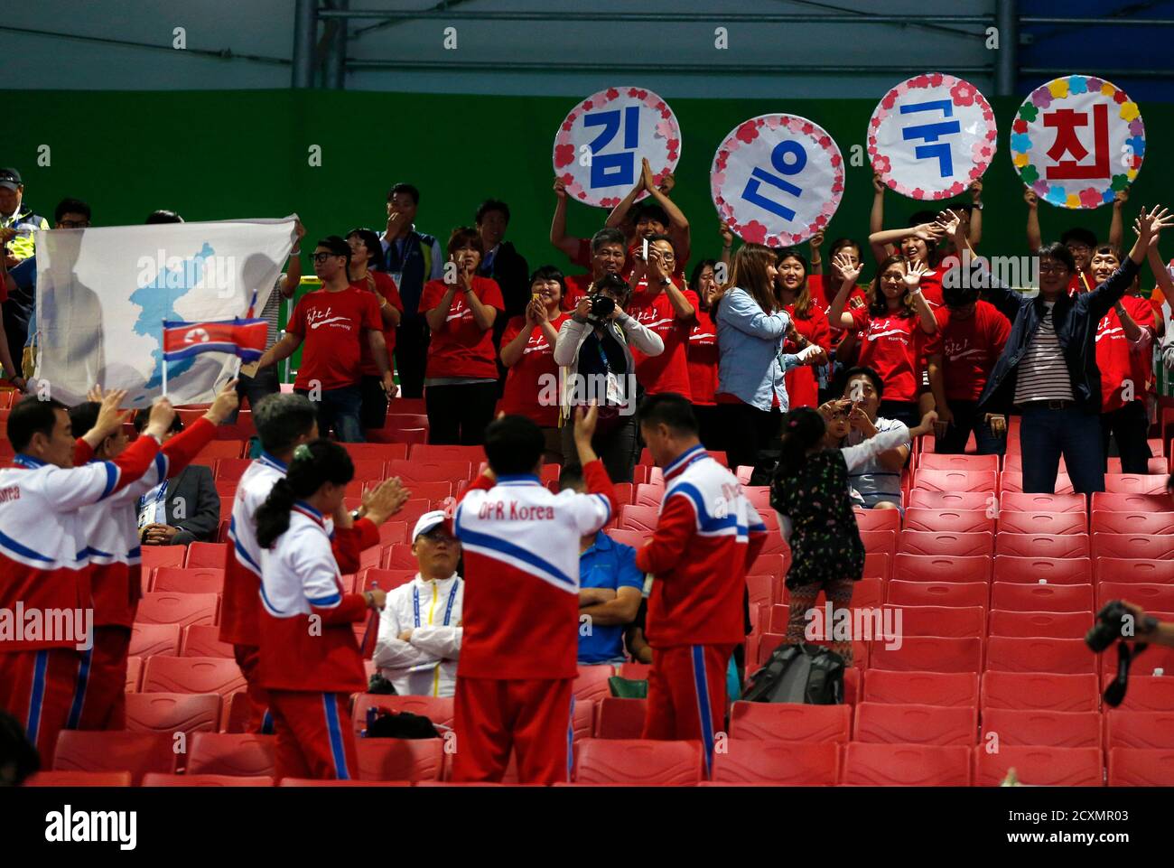 North Korean Bottom And South Korean Spectators The Latter Holding A Map Of North And South Korea As One Land Mass Sing Songs And Wave Flags At Each Other After North Korea S North Korean Bottom And South Korean Spectators The Latter Holding A Map Of North And South Korea As One Land Mass Sing Songs And Wave Flags At Each Other After North Korea S
