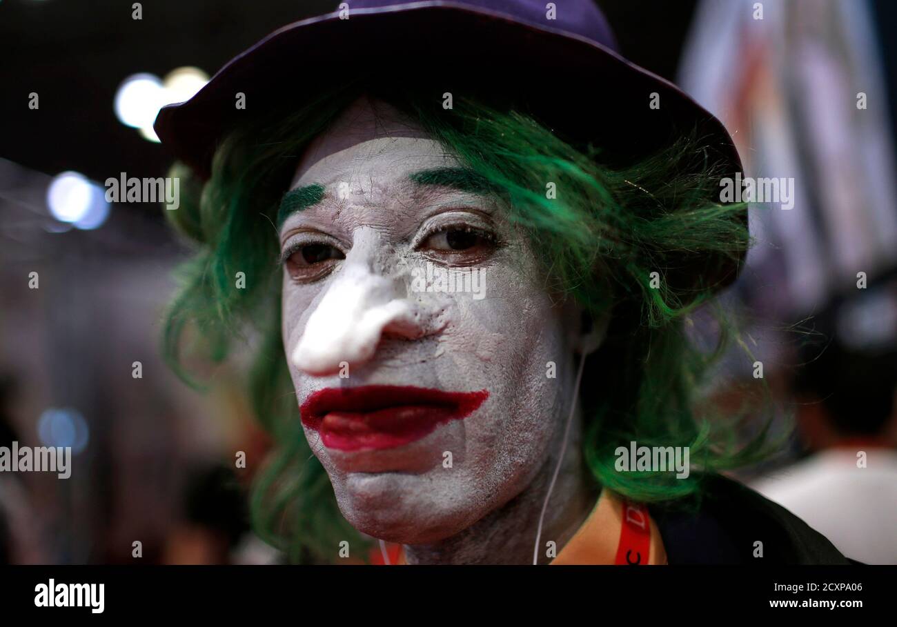 A fan dressed as the Joker from the Batman comic and movie series poses for  a photograph at New York's Comic-Con convention October 11, 2013. The event  draws thousands of costumed fans,