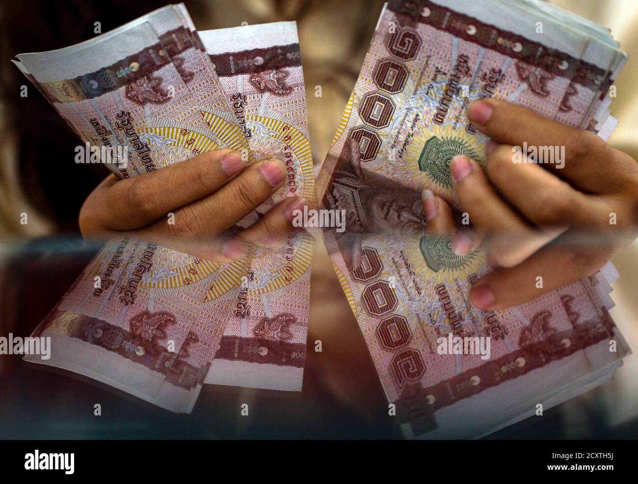 A Pawn Shop Worker Counts Thai Baht Banknotes Before She Purchase Items From A Customer At Easy Money Pawn Shop In Bangkok August 27 13 Faced With Rising Living Costs And Unable A Pawn Shop Worker Counts Thai Baht Banknotes Before She Purchase Items From A Customer At Easy Money Pawn Shop In Bangkok August 27 13 Faced With Rising Living Costs And Unable