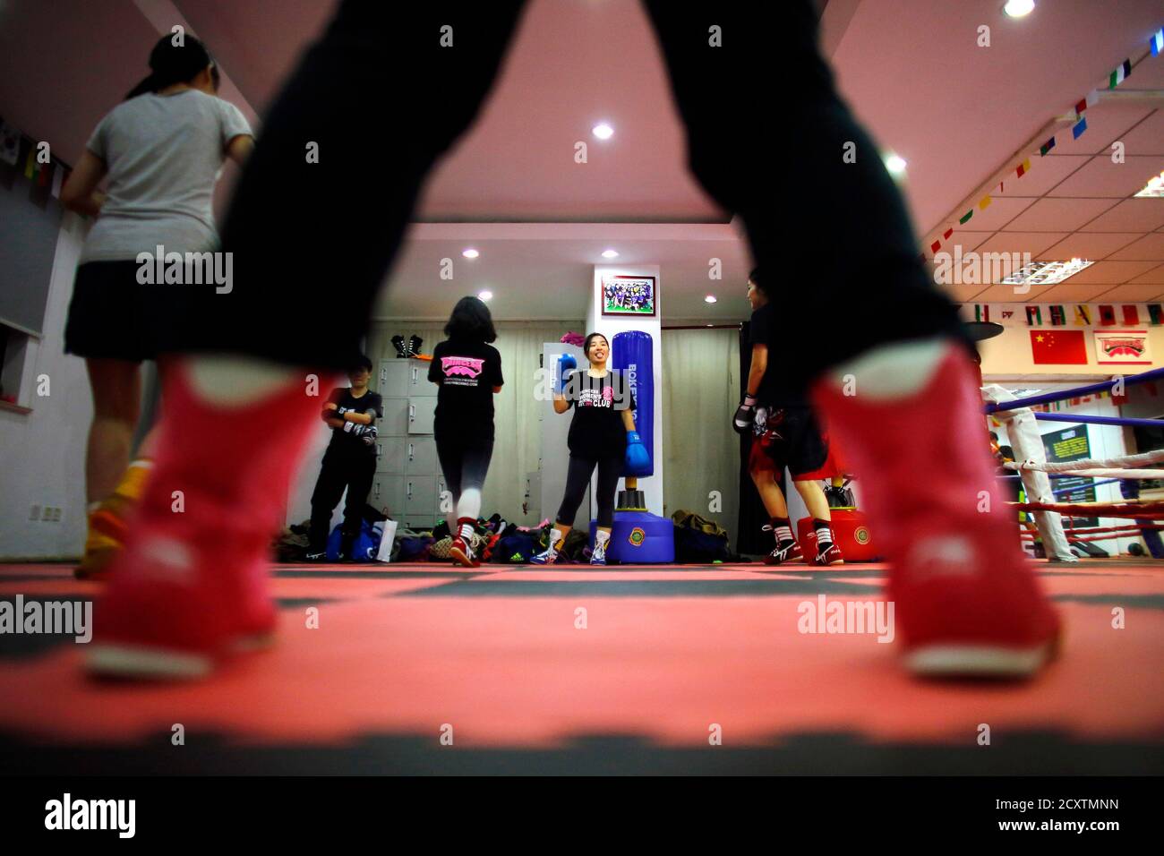 Women attend a boxing class at Princess Women's Boxing Club in Shanghai  December 3, 2014. Women have boxed as long as the sport has existed but for  years they were relegated out