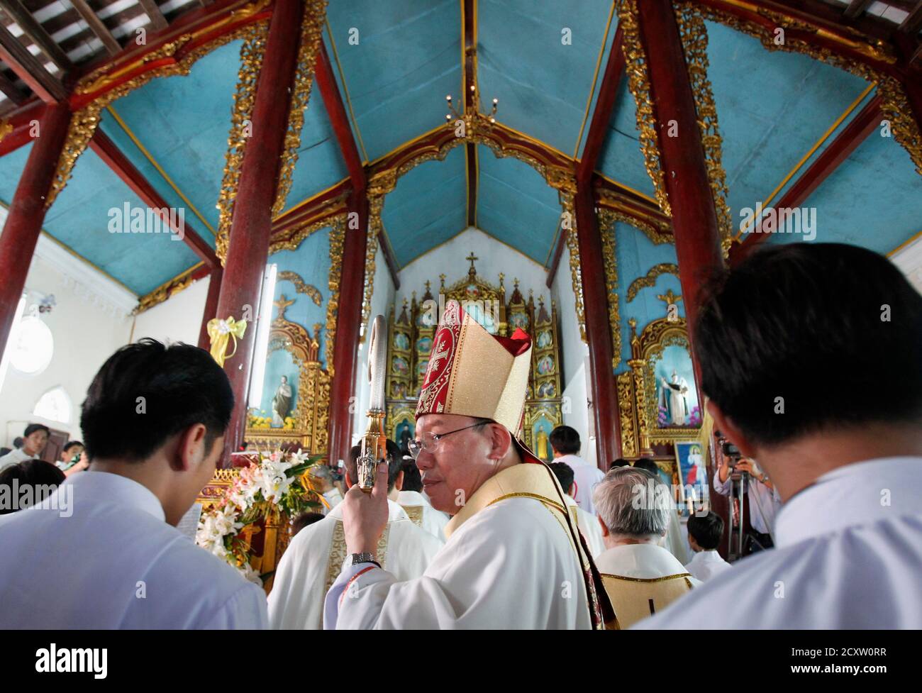 Bishop Joseph Vu Van Thien (C) blesses the congregation during an  installation ceremony for Catholic priest Joseph Nguyen Tien Dung in Thuy  Lam, 60 km (37 miles) east of Hanoi July 21,