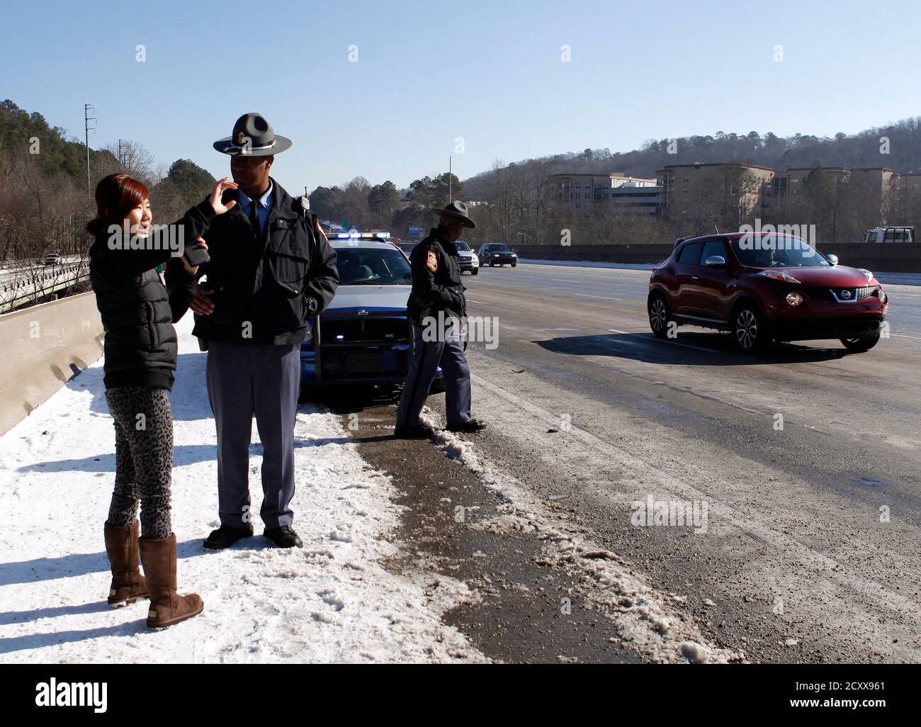 Georgia State Trooper H. Baylor (C) talks to Jenny Tjoewan (R ...