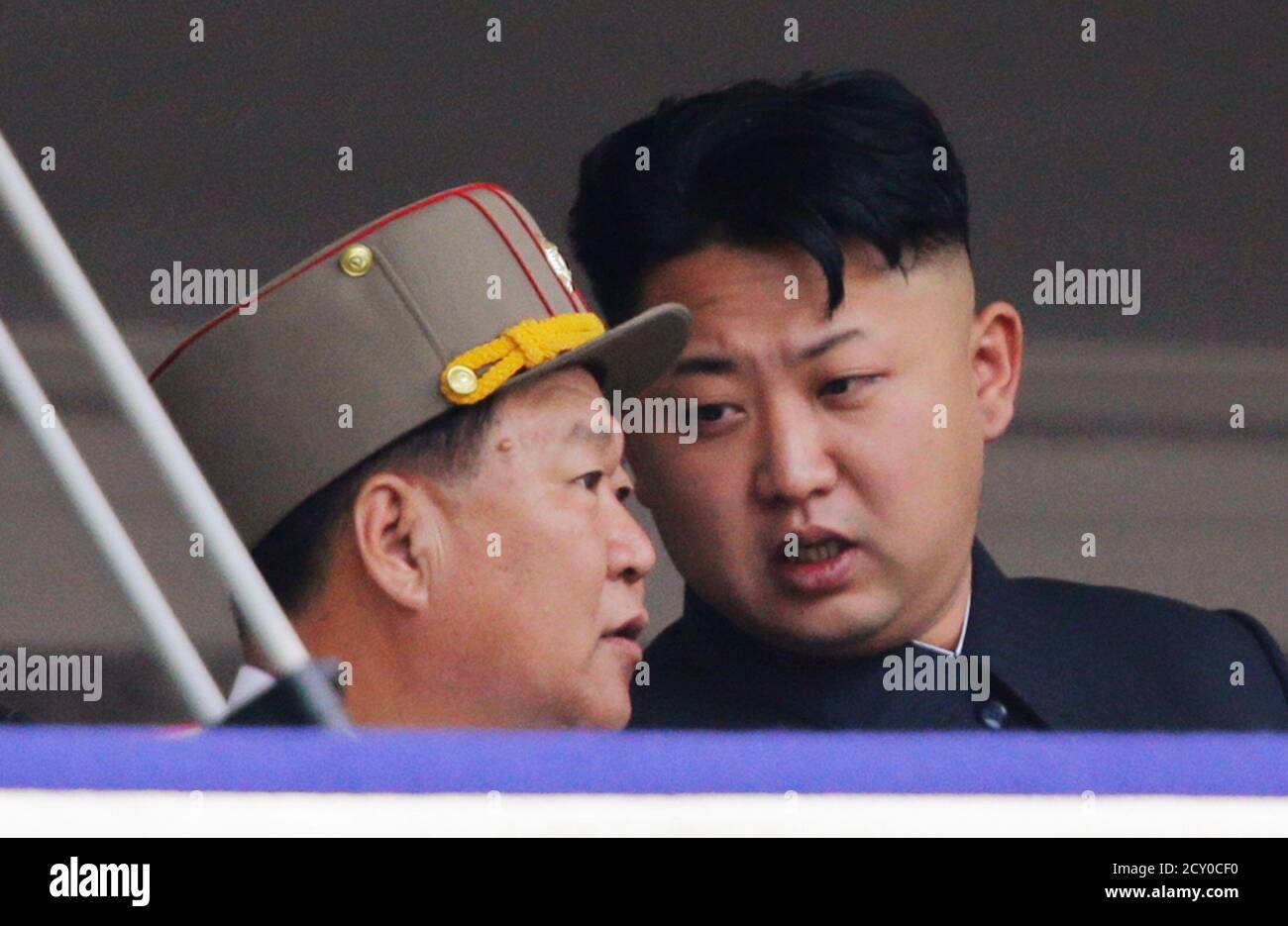 North Korean leader Kim Jong-un speaks to Choe Ryong-hae (L), director of  the General Political Bureau of the Korean People's Army (KPA), during a  parade to commemorate the 60th anniversary of the