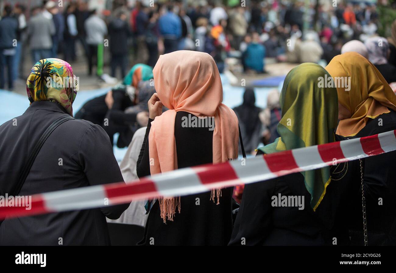 Muslim women with headscarves wait after Friday prayers on Skalitzer  Strasse (street) in Berlin September 19, 2014. More than 2,000 German  mosques have invited Germans of all religions to join their Friday
