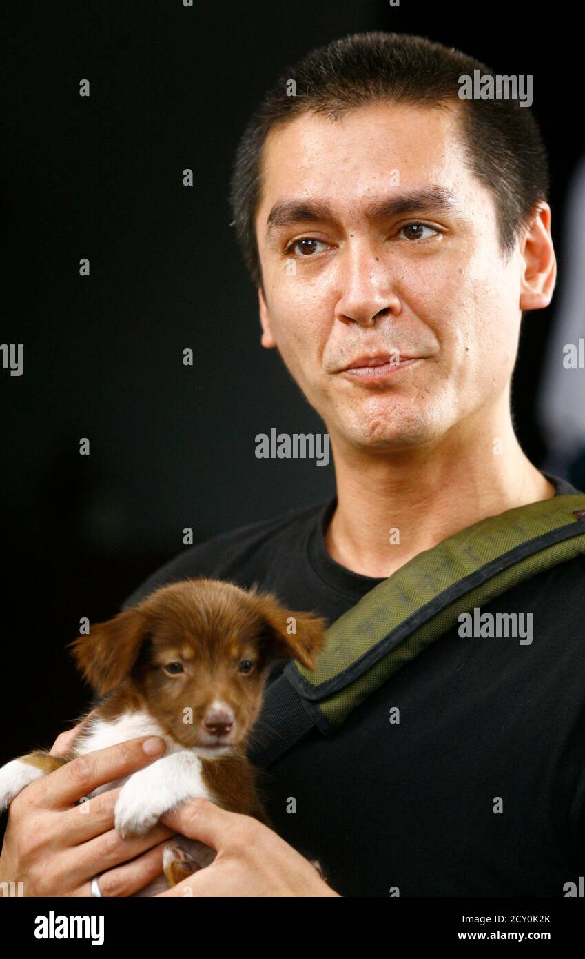 Kim Aris Son Of Myanmar S Pro Democracy Leader Aung San Suu Kyi Holds A Puppy As He Arrives Back To His Mother S House In Yangon November 27 2010 Aris The Younger Of Two