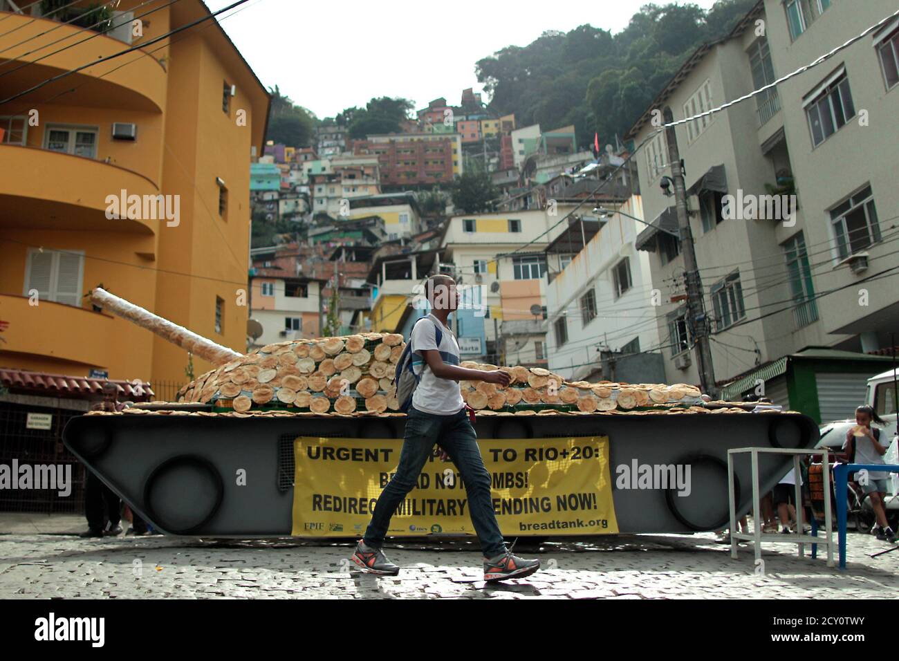 A Boy Passes A Life Sized Model Of A Tank Covered With Bread On Display At Morro Santa Marta The First Pacified Favela Ahead Of The Rio Conference In Rio De Janeiro June A Boy Passes A Life Sized Model Of A Tank Covered With Bread On Display At Morro Santa Marta The First Pacified Favela Ahead Of The Rio Conference In Rio De Janeiro June