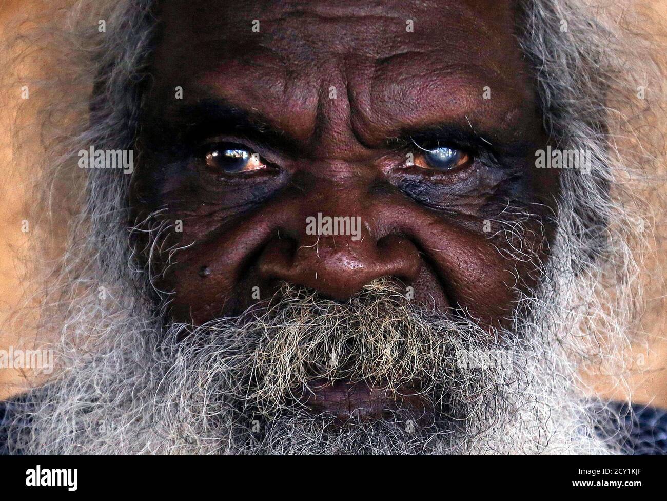 Seventy-six-year-old Australian Aboriginal elder Jimmy Burnyila of the  Yolngu people sits at his house located on the outskirts of the community  of Ramingining located in East Arnhem Land November 21, 2014. The
