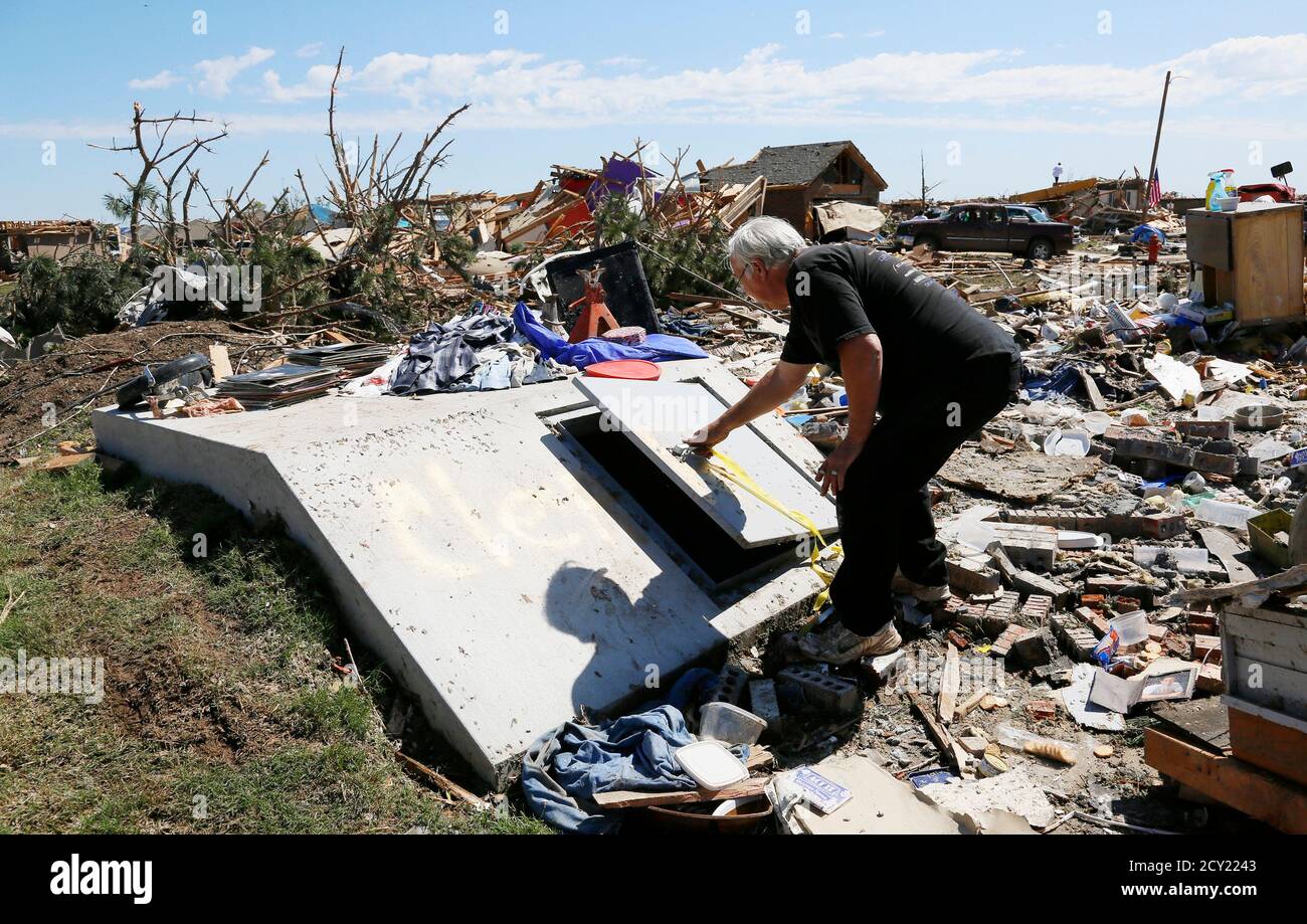 Charles Taber opens the two-week old storm shelter that saved his life in  the May 20 tornado in Oklahoma City, Oklahoma May 22, 2013. Rescue workers  with sniffer dogs picked through the