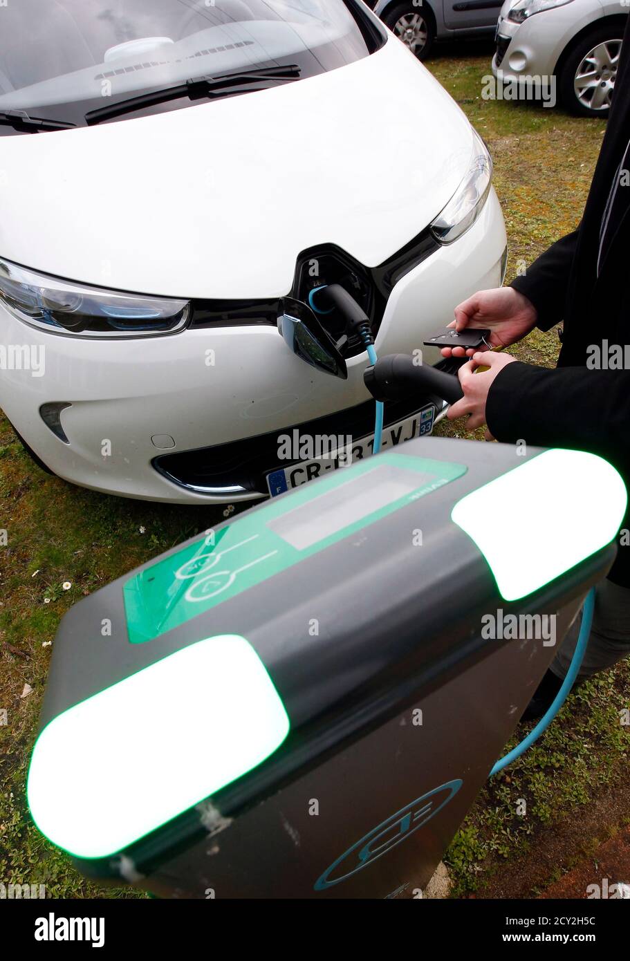 A Man Demonstrates Charging Up A Renault Zoe New Electric Car At A Renault Automobile Dealership In La Teste Southwestern France March 26 2013 France S Power Grid Already Under Strain At Peak