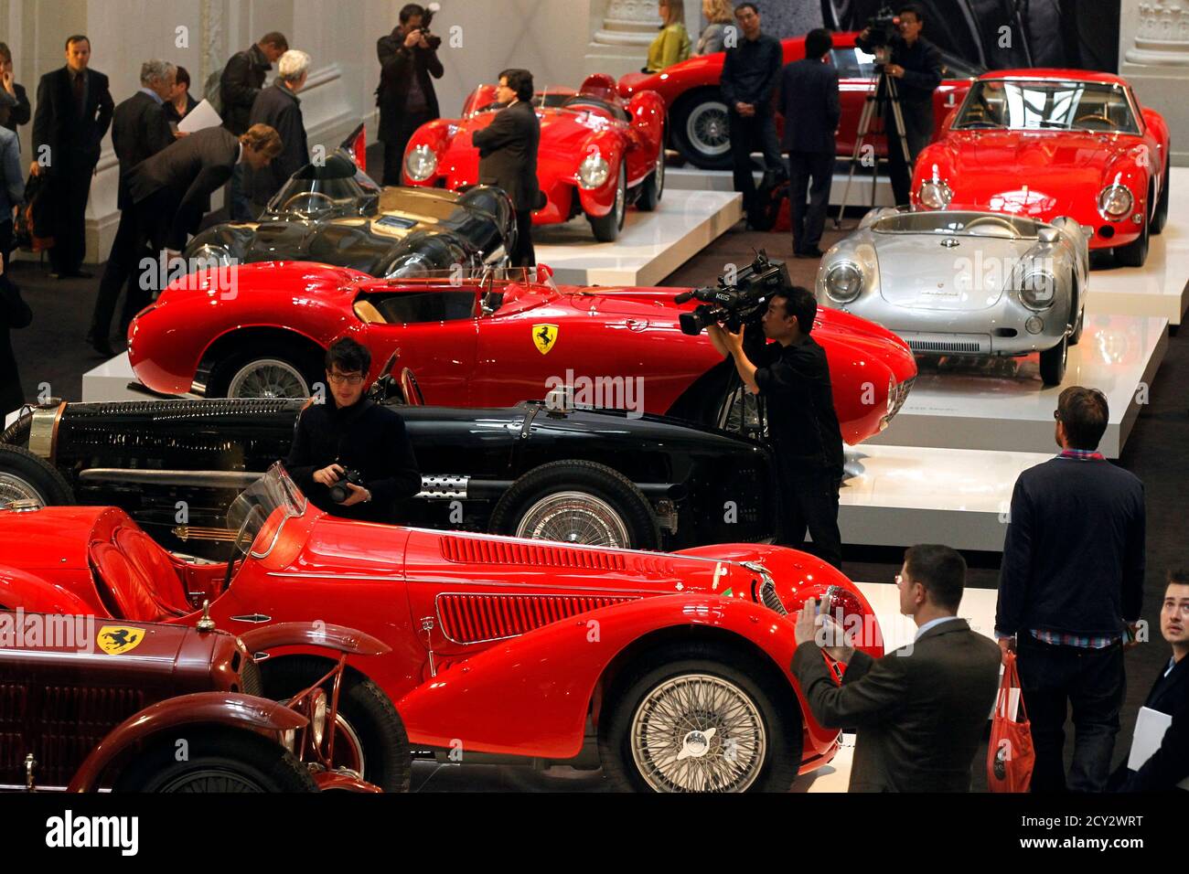 Visitors look at vintage sports cars during the press day of the exhibition  'The Art of the Automobile, Masterpieces from the Ralph Lauren Collection'  at Les Arts Decoratifs Museum in Paris April