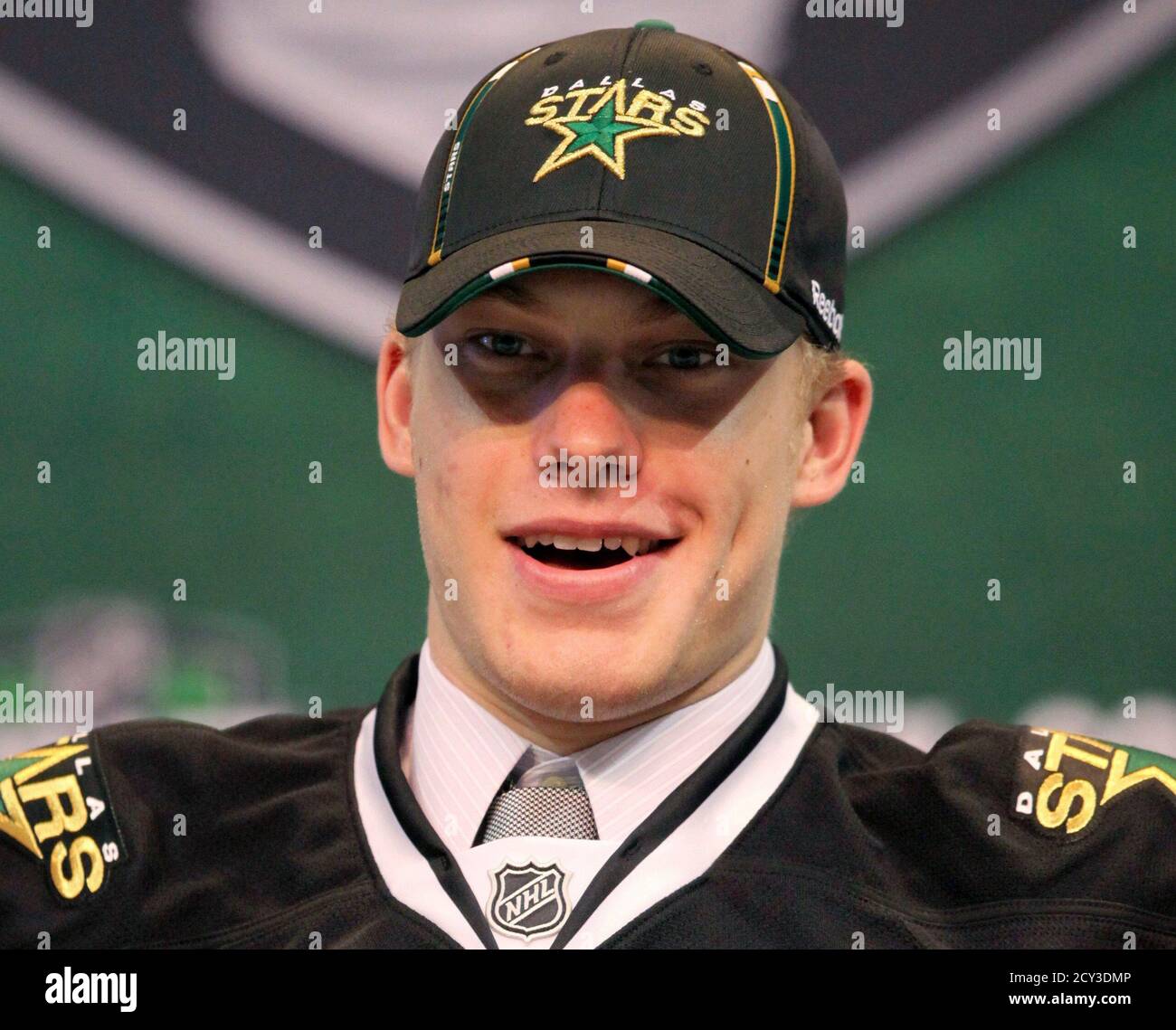 Jamieson Oleksiak wears a Dallas stars hat and jersey after being picked in  the first round at the 2011 NHL hockey draft in St. Paul, Minnesota, June  24, 2011. REUTERS/Eric Miller (UNITED