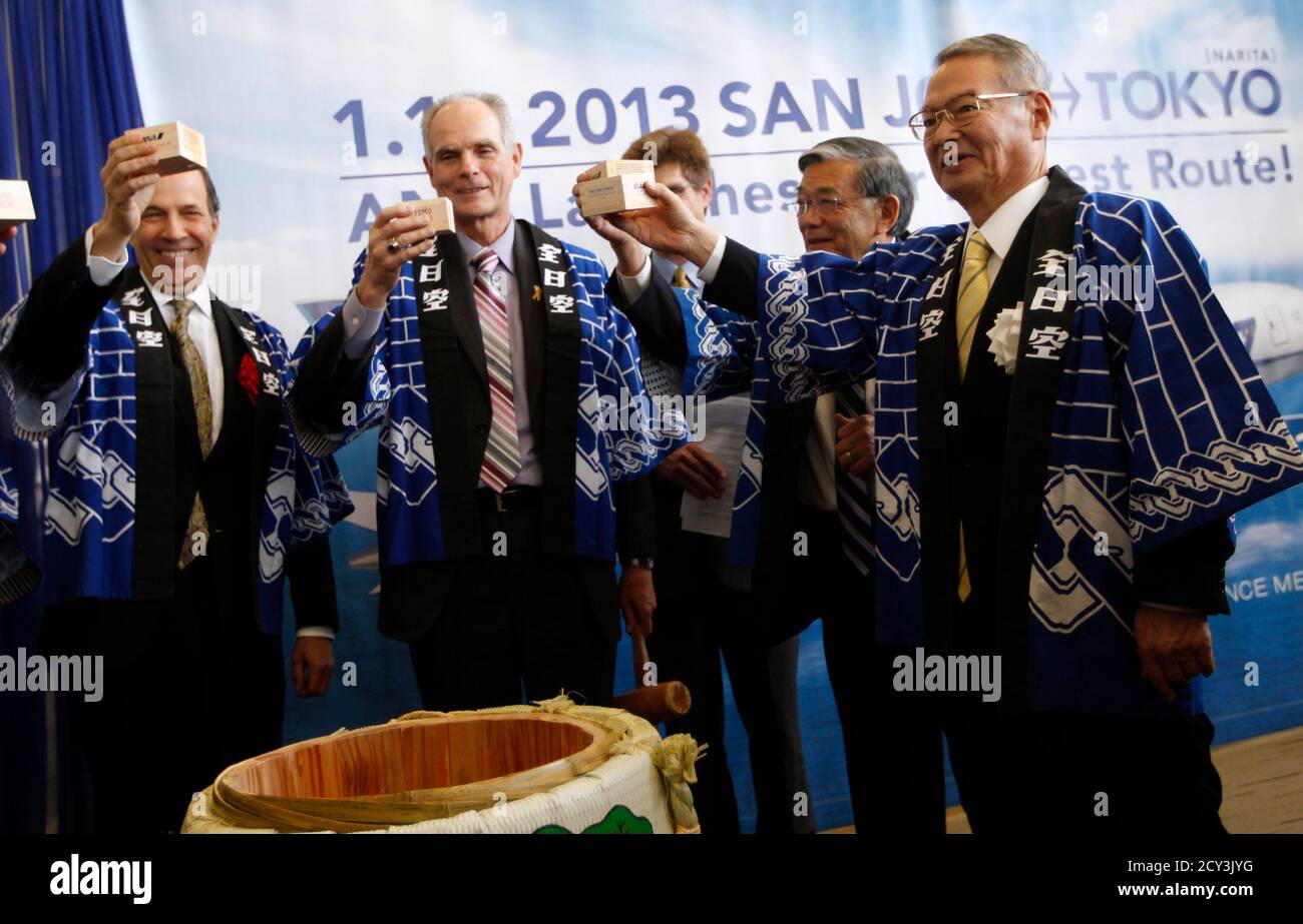 All Nippon Airways Chairman of the Board Yoji Ohashi (R) offers a toast  following a Kagamiwari ceremony, or sake barrel breaking and toast, to the  company's Boeing 787 Dreamliner prior to its