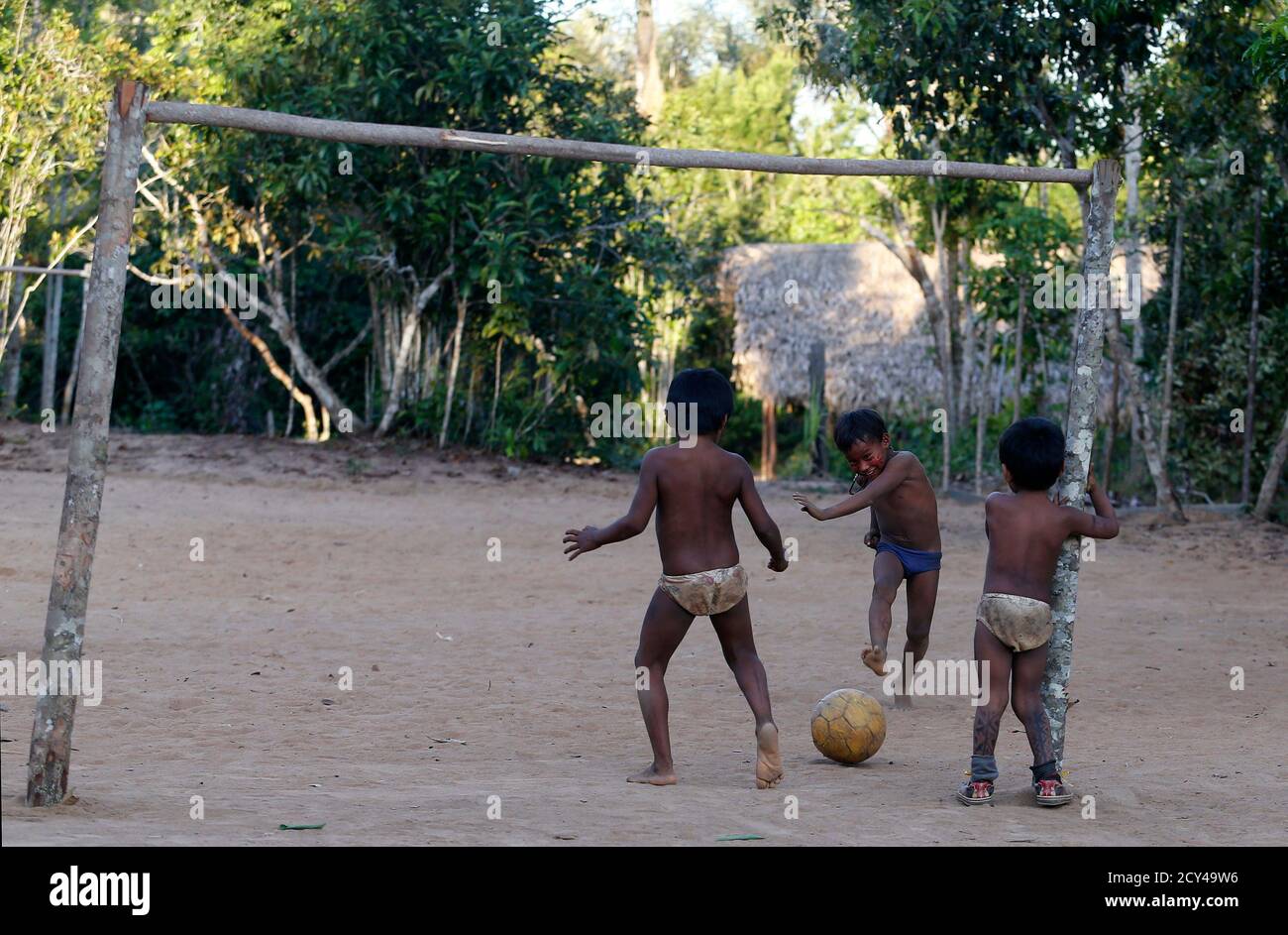 Children of the Amazonian Tatuyo tribe play soccer in their village in the  Rio Negro (Black River) near Manaus city, a World Cup host city, June 23,  2014. Because of their proximity