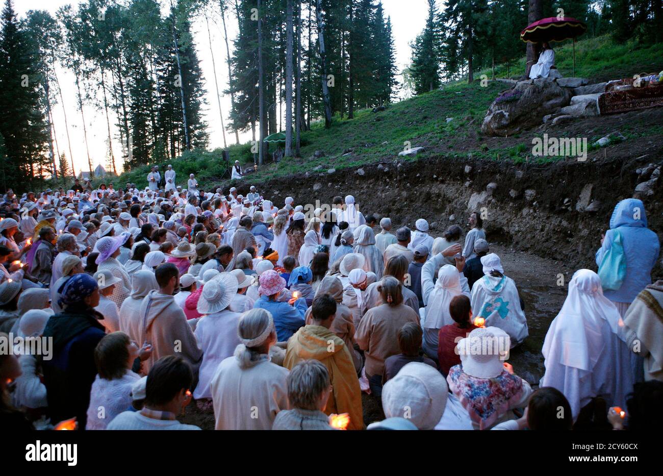 Vissarion (R, top), who has proclaimed himself a new Christ, conducts a service during the