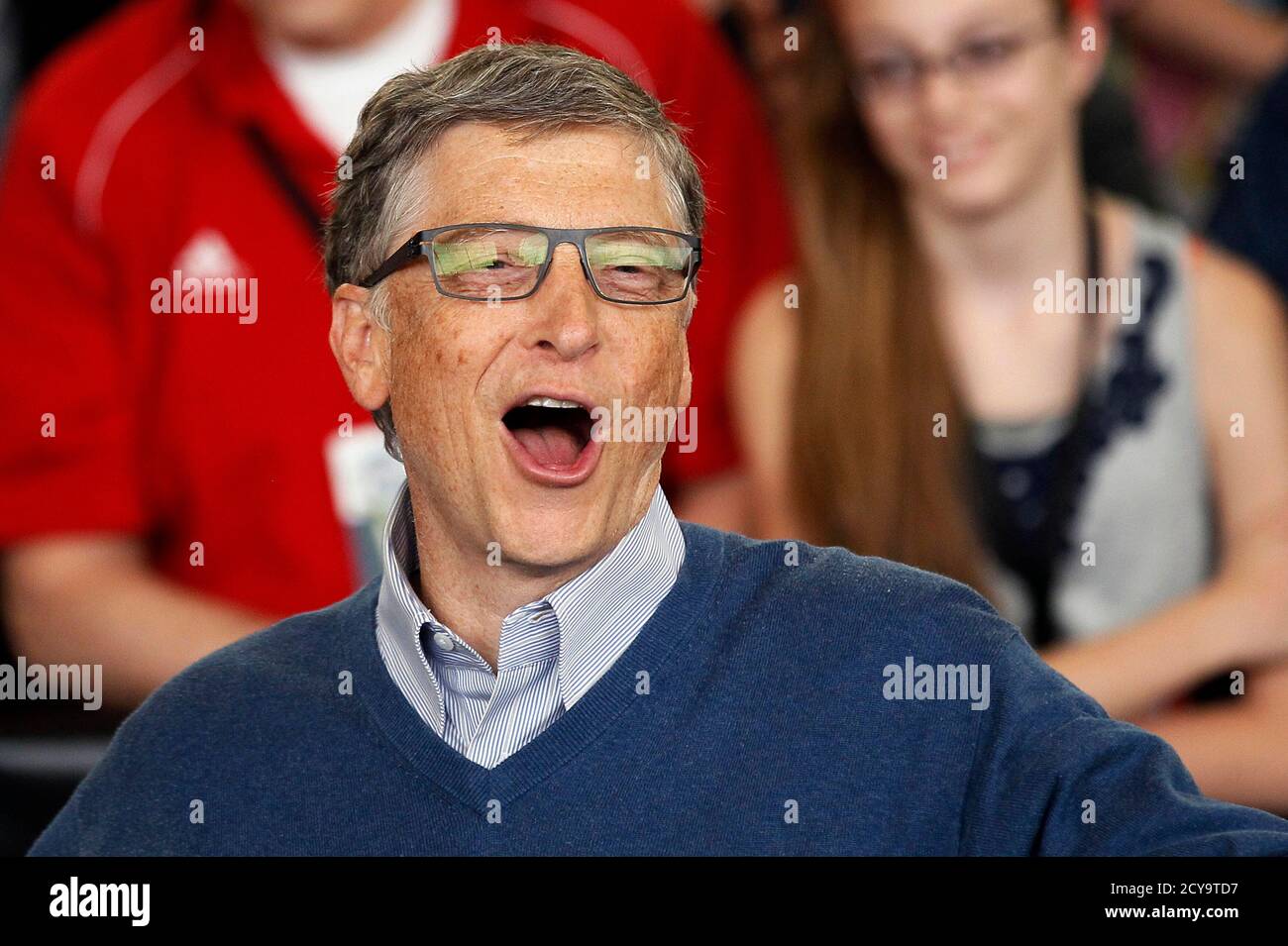 Microsoft founder Bill Gates reacts as he plays table tennis at a Berkshire  Hathaway sponsored reception in Omaha, Nebraska May 4, 2014 as part of the  company annual meeting weekend. Gates is