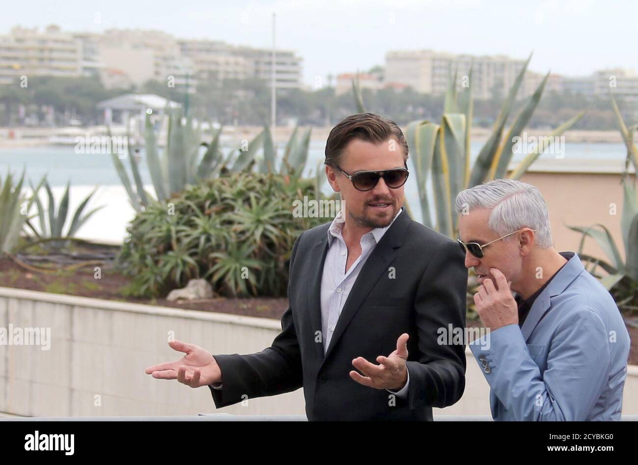 Director Baz Luhrmann (R) and cast member Leonardo DiCaprio leave after a  photocall for the film 'The Great Gatsby' before the opening of the 66th  Cannes Film Festival in Cannes May 15,