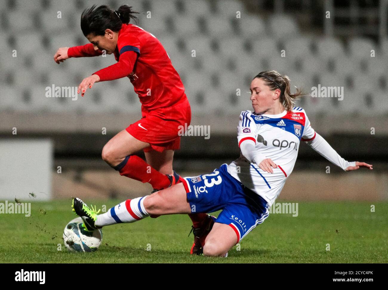 Olympique Lyon's Camille Abily (R) tackles Paris St Germain's Dali Kenza  during their women's Ligue 1 soccer match at Gerland stadium in Lyon March  2, 2013. Lyon defeated Paris 3-0 and is