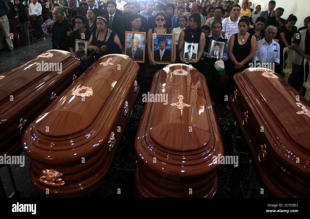 Relatives Of The Nine Farmers Killed By The Grupo Colina Death Squad In 1992 Hold Their Photos Next To The Coffins During A Mass Before Their Funeral In The Village Of Santa