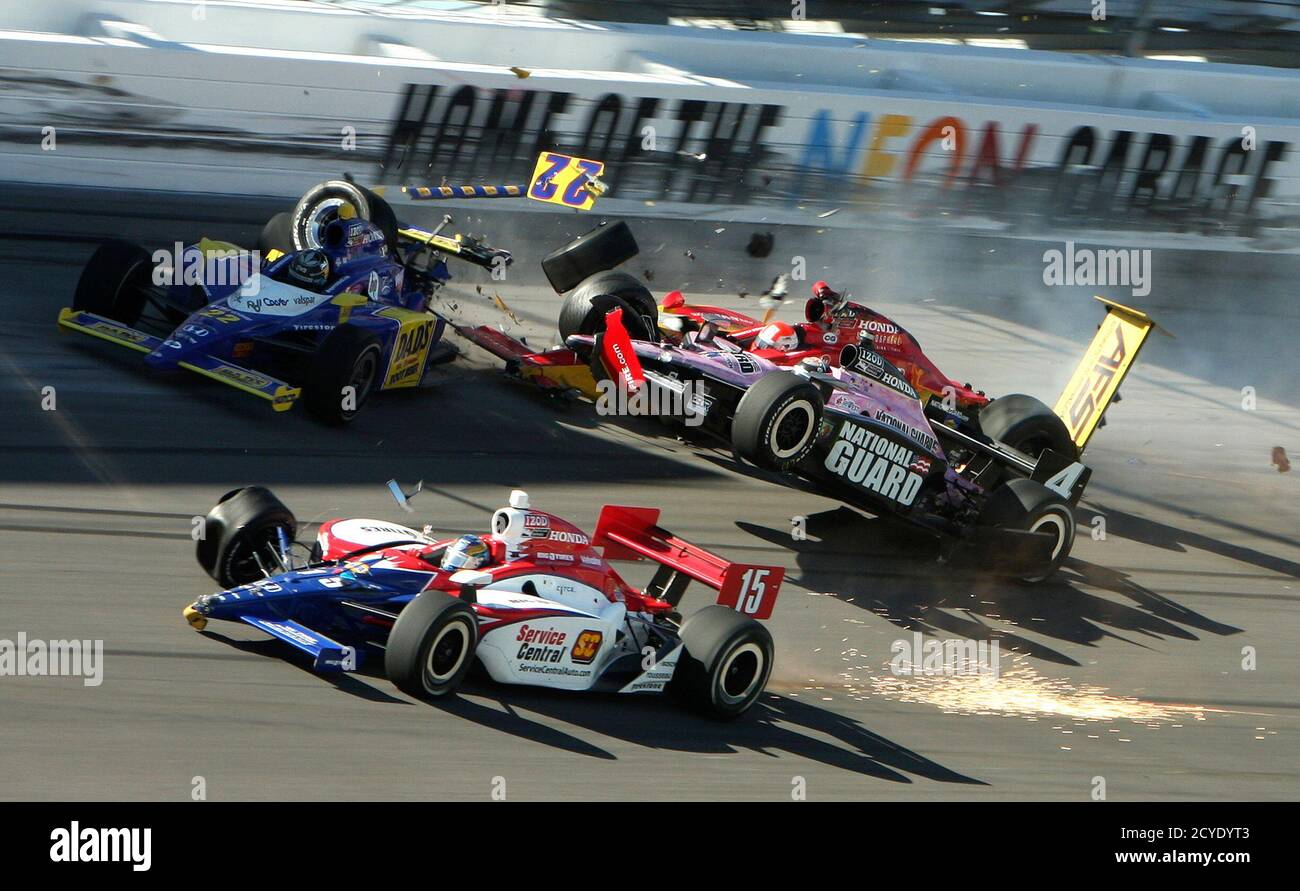 The race car of driver J.R. Hildebrand (R) lifts off the ground next to  drivers Townsend Bell (L) and Jay Howard (C) during the IZOD IndyCar World  Championship race at the Las