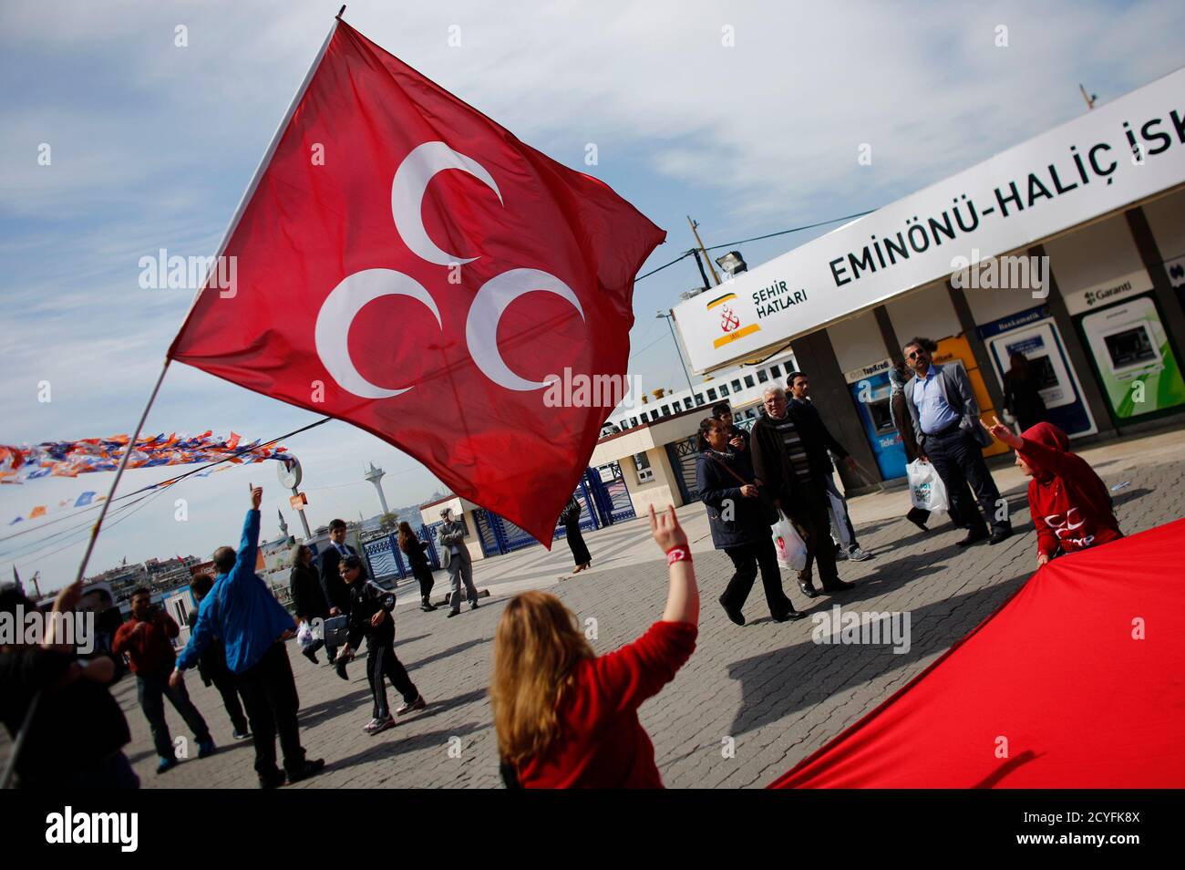 Members of Nationalist Movement Party (MHP) wave a party flag during an  election campaign in Istanbul March 27, 2014. To the adulation of the  cheering crowds at his election rallies, Prime Minister