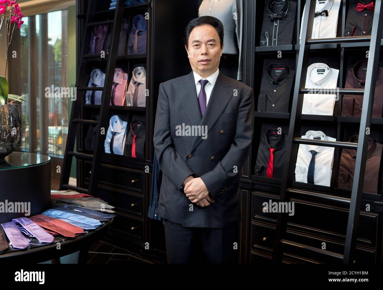 Bosideng founder and chairman Gao De Kang poses for photographs during the  opening of Bosideng's first overseas flagship store in London October 12,  2012. Bosideng International Holdings, China's largest maker and distributor
