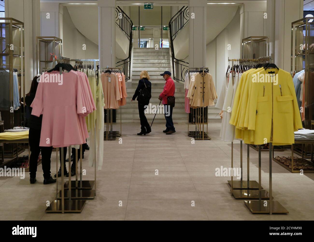 People walk inside a Zara store in central Madrid March 18, 2014. Inditex,  the world's biggest fashion retailer, will accelerate investment in 2014 to  open more new stores after results last year