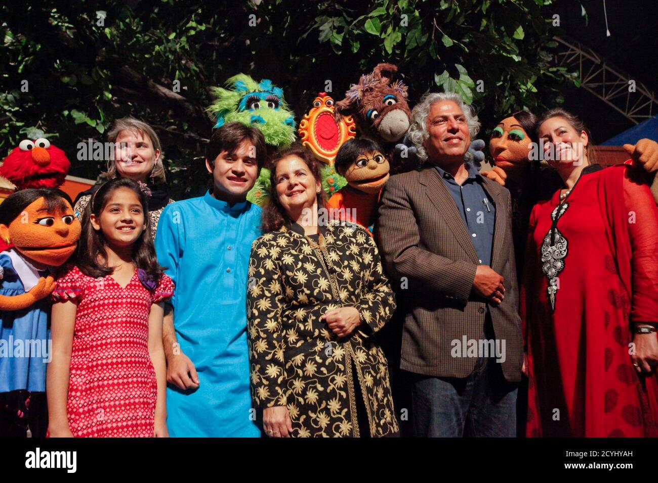 American Consulate General Nina Fite (C) poses for a group photo and the  production team with Sesame Street and locally developed puppet characters  during the launching ceremony the Pakistani version of Sesame